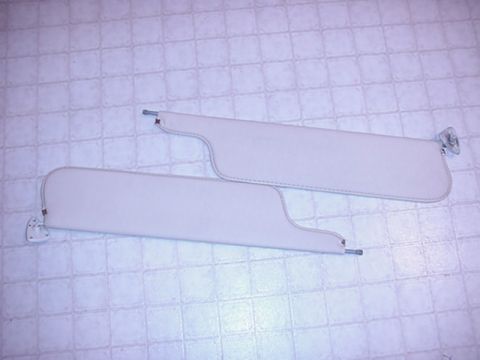 1979 Ford Bronco - A pair of light-colored sun visors are shown, likely interior parts for a vehicle.