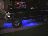 1994 Ford Bronco - A black SUV is shown with vibrant blue underglow lighting illuminating the ground beneath it.