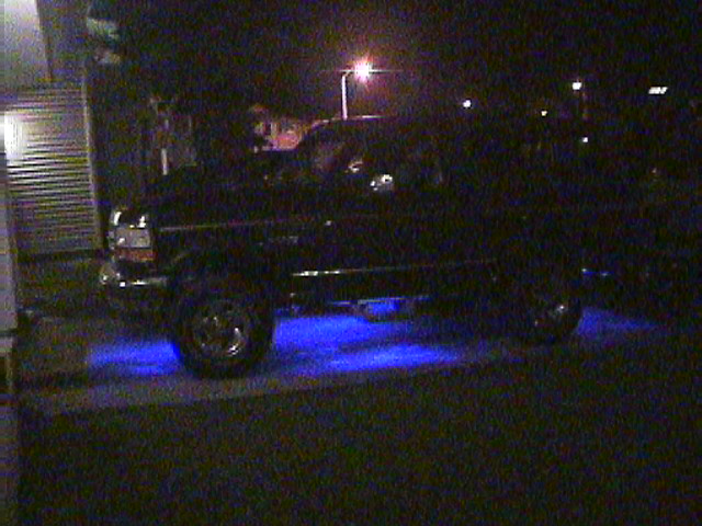 1994 Ford Bronco parked at night with blue underglow lights visible along the side