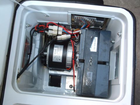 2004 Toyota Tacoma - Close-up view of the internal components, including a motor and electronic modules, housed within a white casing.