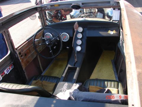 1987 Ford Bronco - The interior of a custom hot rod shows a unique dashboard with multiple gauges and a vintage steering wheel.