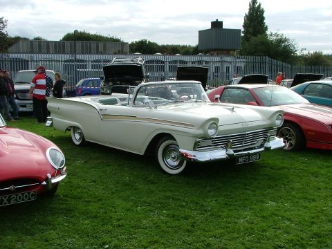 2001 Ford Fiesta - A classic white 1957 Ford Fairlane convertible is displayed at an outdoor event with other vehicles.