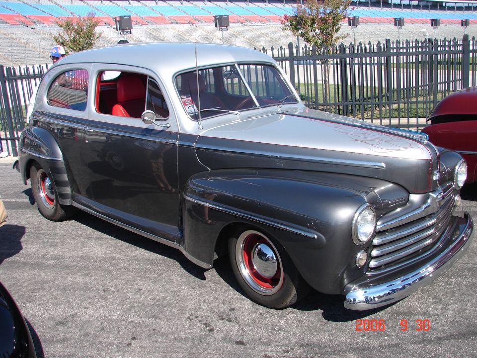 Two-tone gray and silver sedan with red interior, custom wheels