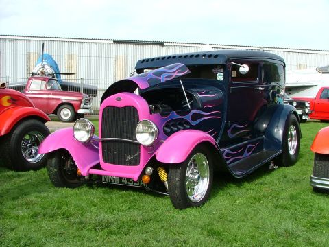 2001 Ford Fiesta - A custom hot rod with a two-tone paint job and flame graphics sits on display on a grassy field.