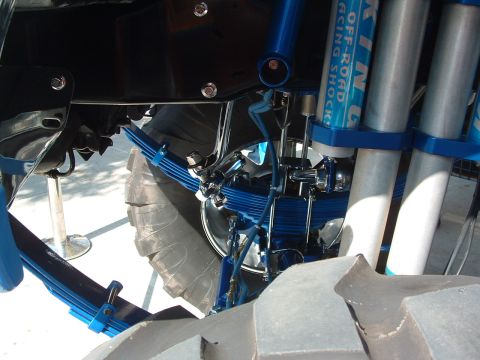 2004 Toyota Tacoma - Custom suspension components, including King Off-Road Racing Shocks and blue leaf springs, are visible on a vehicle with large tires.