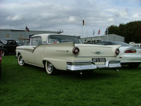 2001 Ford Fiesta - A classic 1957 Ford Fairlane is parked on grass with other vehicles in the background.