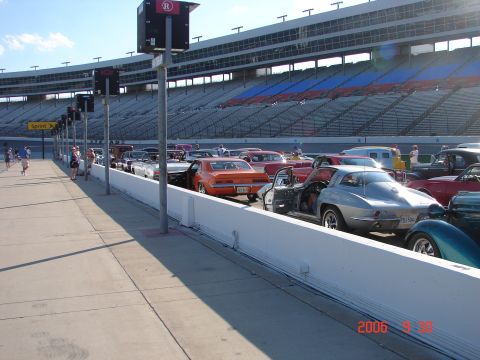 1987 Ford Bronco - Several classic cars are lined up at a stadium, possibly for an event.