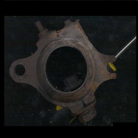 1979 Ford Bronco - A close-up view of a corroded metal component, likely a vehicle part.