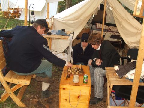 1966 Ford Ranchero - Historical reenactors play chess in a tent, suggesting a Civil War encampment scene.
