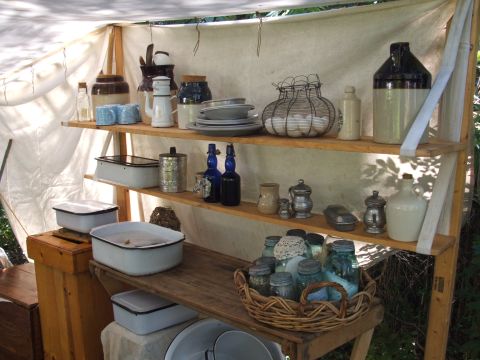 1966 Ford Ranchero - A display of vintage kitchen items and preserved goods is set up on wooden shelves under a canopy.