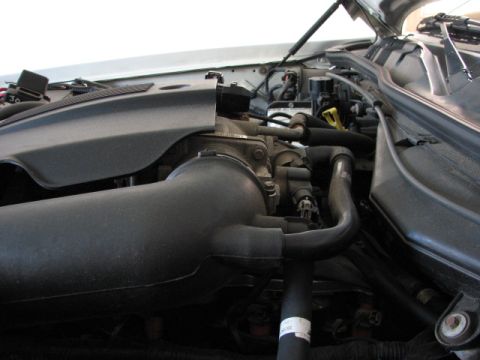 2003 Ford Crown Victoria - Close-up view of an engine bay, showing various components and hoses.