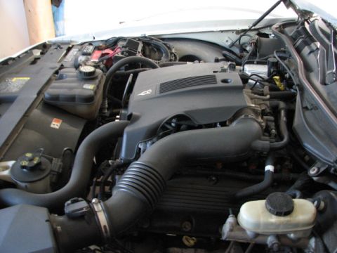 2003 Ford Crown Victoria - The engine bay of a vehicle, showing various components and wiring under the hood.