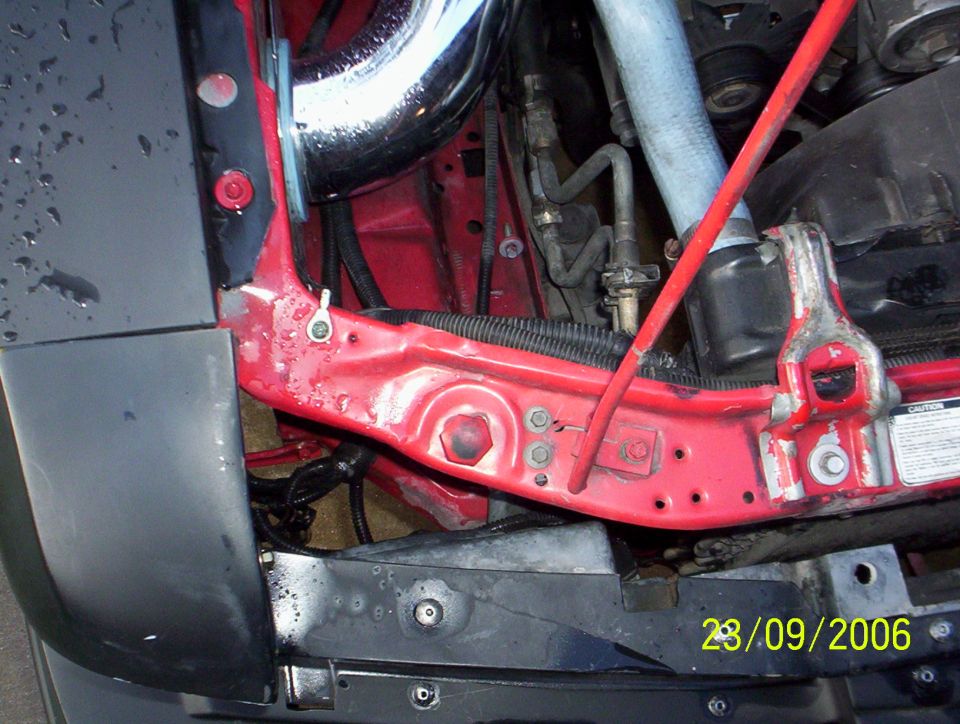 Engine bay with red bracing and chrome intake pipe