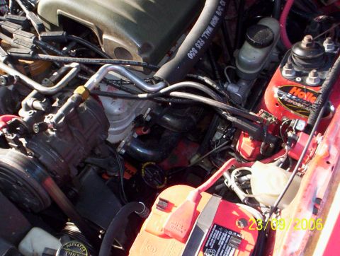 1990 Ford Mustang - A detailed view of the engine compartment, showing complex mechanical components and wiring.