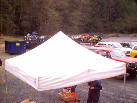 1976 Ford F-100 - A red 1976 Ford F-100 pickup truck is visible in the foreground, partially obscured by a white tent.