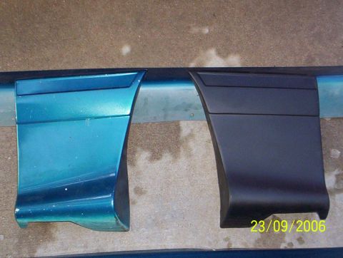 1990 Ford Mustang - Two car door trim pieces are shown side-by-side, one in teal and the other in black.