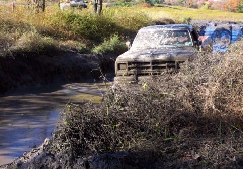 1979 Ford Bronco - This truck is covered in mud and appears to be stuck in a muddy ditch.