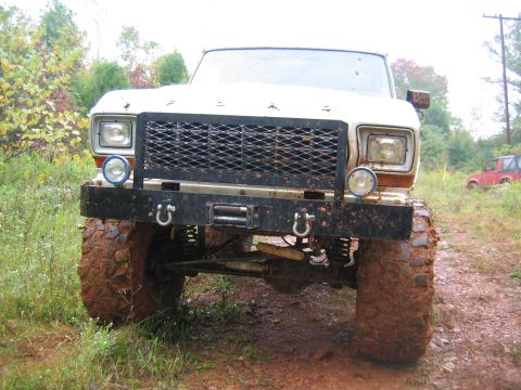 1992 Ford Mustang - This heavily modified pickup truck is covered in mud, suggesting it has been used for off-roading.