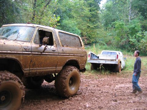 1992 Ford Mustang - Two mud-covered trucks, a Ford Bronco and a pickup, are stuck in the mud at Rock Creek.