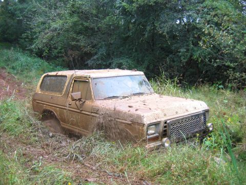 1992 Ford Mustang - A mud-covered 1978 Ford Bronco is stuck in the mud off-road.