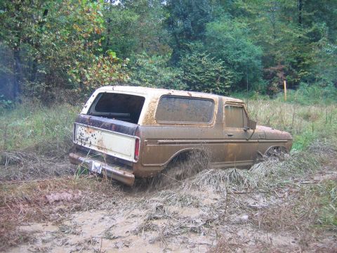 1992 Ford Mustang - This 1978 Ford Bronco is stuck deep in the mud, with its rear wheels spinning in the mire.