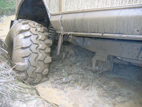 1992 Ford Mustang - This vehicle is stuck in the mud, with its tire deeply embedded in the mire.