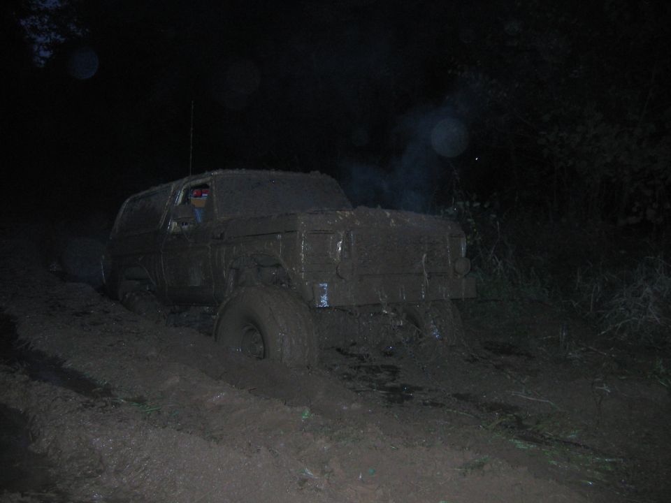 Mud-covered SUV stuck in mud