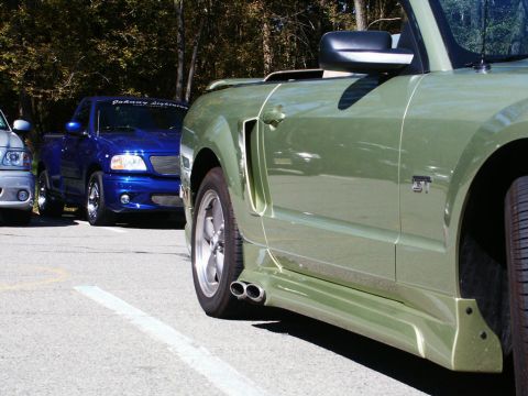 2001 Mercury Grand Marquis - Two vehicles parked side-by-side, a green convertible and a blue pickup truck.