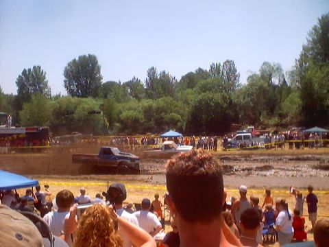 1976 Ford F-100 - A blue 1976 Ford F-100 navigates a muddy track during a competition.
