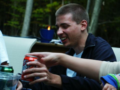 2001 Mercury Grand Marquis - People enjoy drinks and a fire at an outdoor gathering.