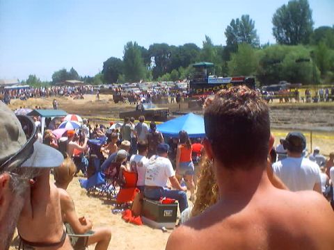 1976 Ford F-100 - Spectators gather to watch a mud bogging competition on a sunny day.