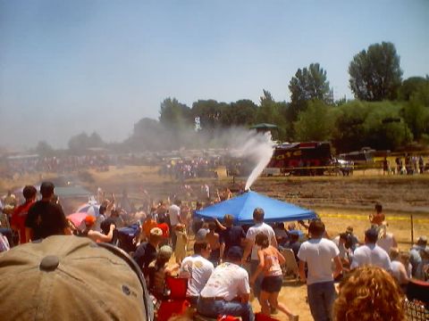 1976 Ford F-100 - An outdoor event with a crowd of people and a water feature spraying into the air.