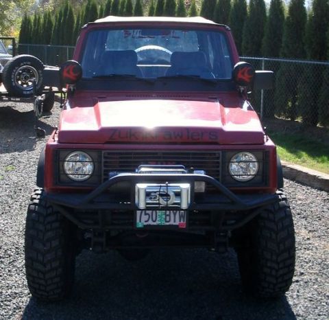 1987 Suzuki Samurai - Red 1987 Suzuki Samurai modified for off-roading, a winch and large tires.