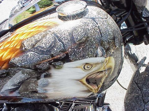 1999 Harley-Davidson Fat Boy - Custom painted motorcycle gas tank features an eagle's head and feathers with a rocky texture and chrome accents.