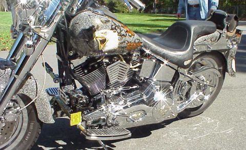 1999 Harley-Davidson Fat Boy - This custom motorcycle features a striking eagle graphic on its fuel tank and numerous chrome details.