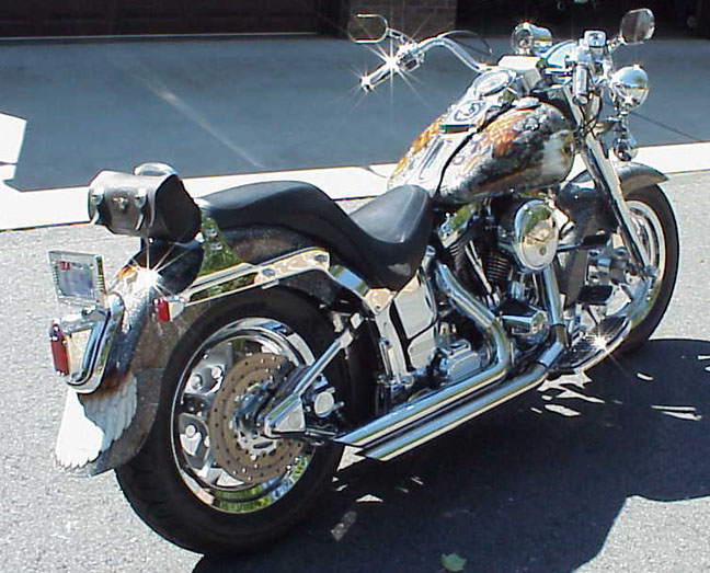 Chromed Harley-Davidson softail with airbrushed eagle tank art, rear three-quarter view