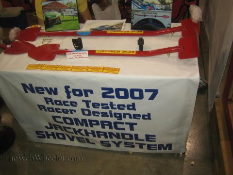 1990 Ford Bronco - vendor table displays red collapsible jack-handle shovels above a banner reading New for 2007 Compact Jackhandle Shovel System.