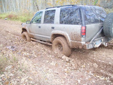 2000 Chevrolet Tahoe - Silver 2000 Chevrolet Tahoe stuck in mud on a dirt road.