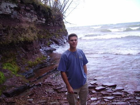 2000 Chevrolet Tahoe - A man poses for a photo on a rocky shoreline with choppy water and a cliff face.