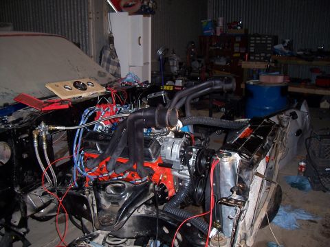 1979 Chevrolet Camaro - Engine bay components including V8 engine, headers, and radiator in a garage setting.