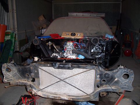 1979 Chevrolet Camaro - The engine bay of a car, possibly from the 1970s, is shown with the engine exposed and the radiator removed.
