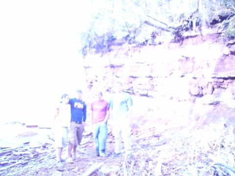 2000 Chevrolet Tahoe - A group of friends poses for a photo near a cliff by the water.