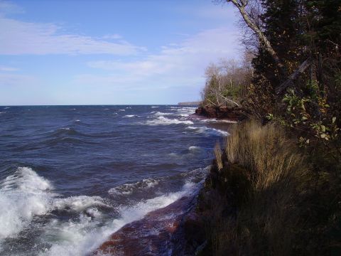 2000 Chevrolet Tahoe - Waves crash against the rocky shore of a lake or ocean on a breezy day.