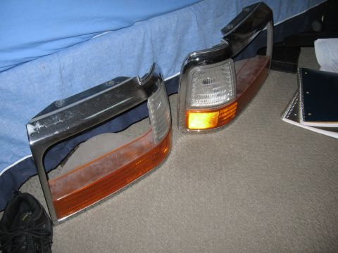 1974 Ford F-100 - Two truck marker lights, likely for the front corners, are shown. One light has a chrome bezel and amber lens.