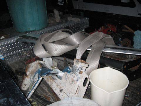 1974 Ford F-100 - A truck bed is filled with various items, including a large blue bucket and tie-down straps.