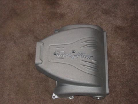 1991 Ford Bronco - A gray Trick Flow intake manifold is shown against a brown carpet background.