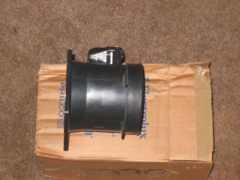 1991 Ford Bronco - A black mass air flow sensor rests on a cardboard box with partial text visible.