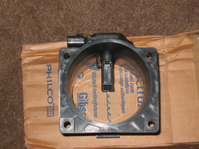 Black mass air flow sensor on a cardboard box with Philco and White-Westinghouse branding