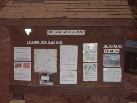 1993 Ford Bronco - A trail information kiosk displays maps and details about Dinosaur Tracks and Poison Spider Mesa.