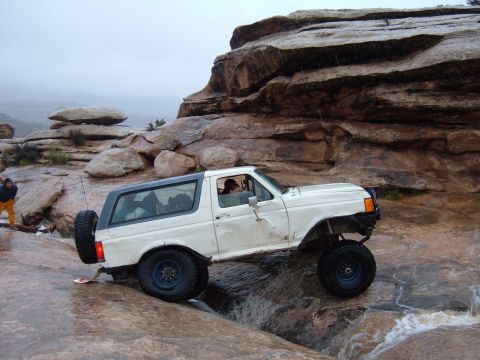 1993 Ford Bronco - This 1993 Ford Bronco tackles a challenging off-road course with large rocks and water features.